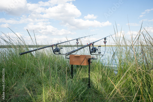 Fishing Rods by Water in Grass