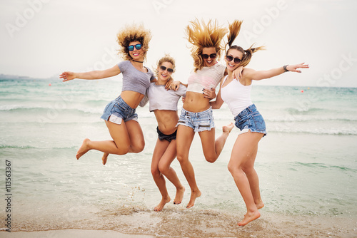 Photos Young attractive teenagers jumping at beach