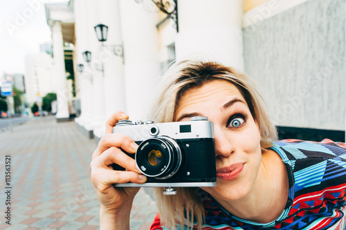 Woman photographed retro camera in the city