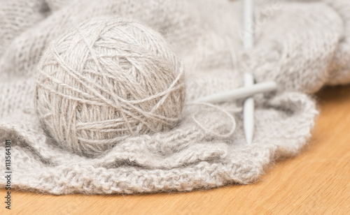Ball of soft wool yarn and knitting needles