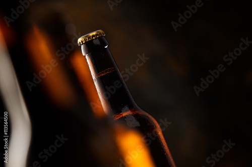 Tilted angle view of a glowing beer bottle