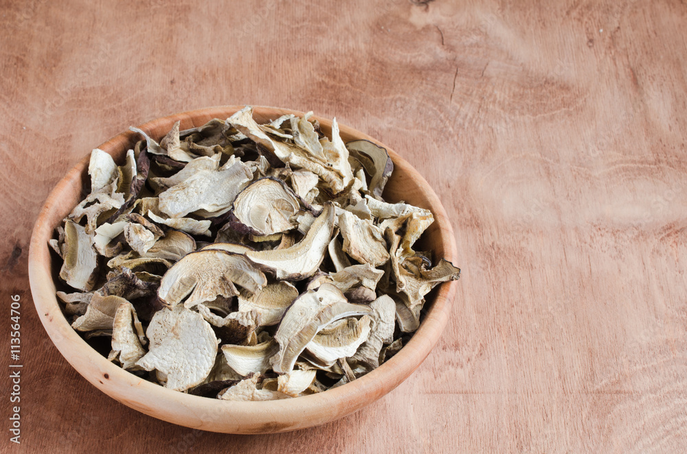 Dried porcini mushrooms on a wooden table. Rustic style. Dried porcini mushrooms on a wooden table. Rustic style.