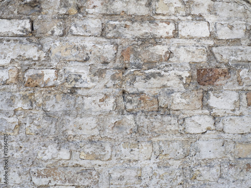 Old damaged rustic brick wall with plaster texture background