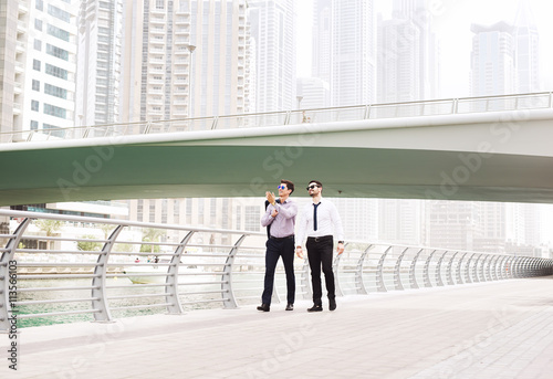 Businessmen walking at Dubai Marina.