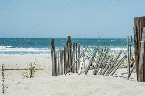 Broken fence on a beach near the ocean