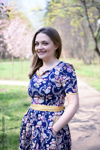 Young woman in front of sakura trees