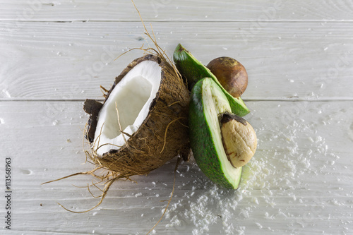 fresh, delicious coconut with avocado on a wooden white background