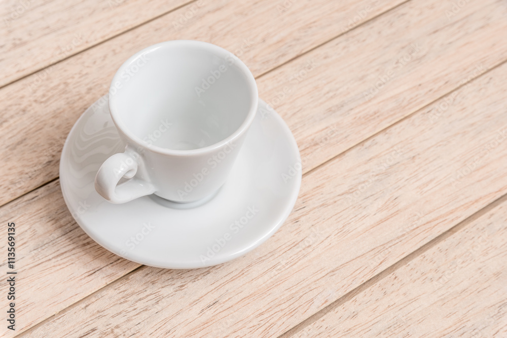 Cup of coffee beans with a spoon and saucer on a white background with the outline of more coffee beans Cup of coffee beans with a spoon and saucer on a white background with the outline of more coffee beans