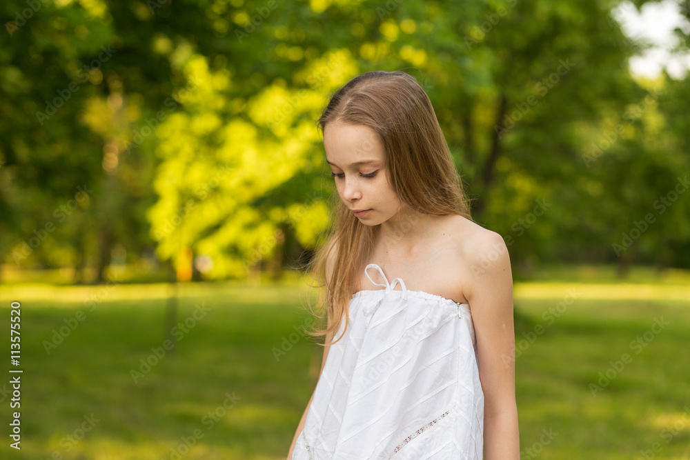 Outdoors portrait of beautiful young girl with long hair