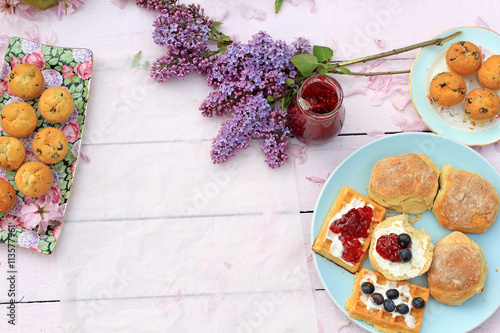 Spring romantic background with lilac with Scottish scones and waffers