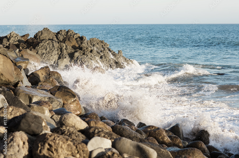 Beach landscape in Malibu. The ocean and waves during strong winds in United States, California. Waves breaking on the rocks.