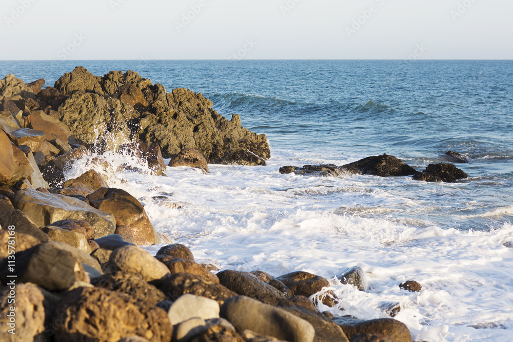 Beach landscape in Malibu. The ocean and waves during strong winds in United States, California. Waves breaking on the rocks.