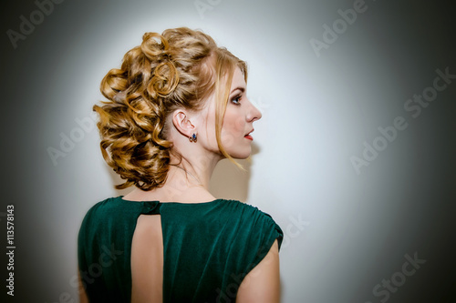 Beautiful girl with elegant coiffure on black and white background.
