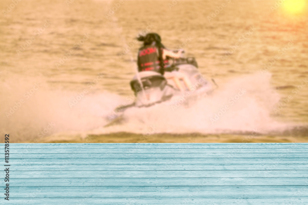 Wooden table with girl on jet ski,blurred background,filter effe