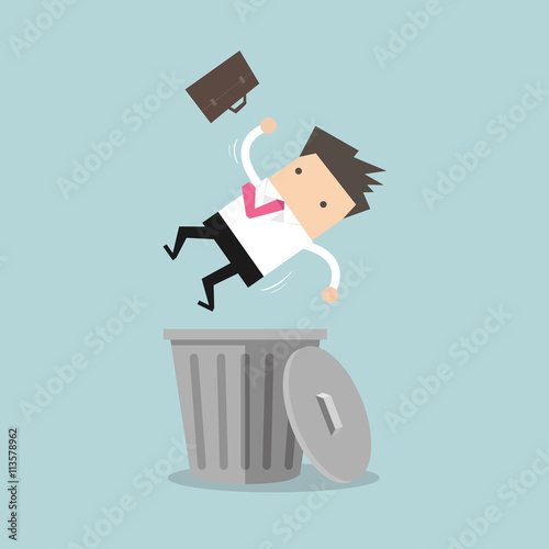 Businessman dropped into trashcan layoff concept photo