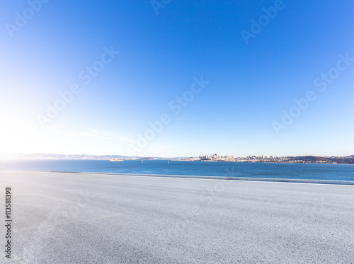 road near water with cityscape and skyline of san francisco