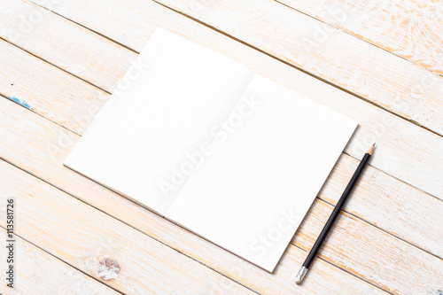 Blank open notebook with pencil on wood table,Business template