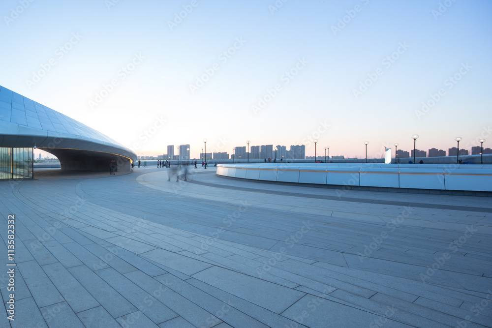 empty square with cityscape and skyline at sunrise in harbin