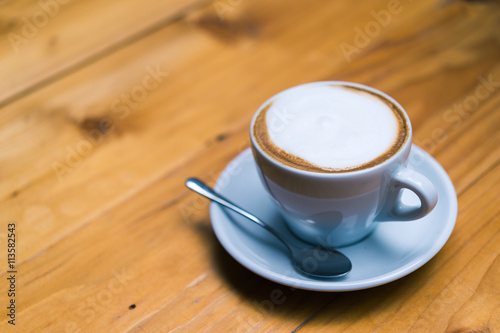 Late art coffee on wood table background