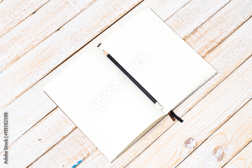 Blank open notebook with pencil on wood table,Business template