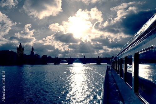 Boat cruise on the Vltava river in Prague, on a sunny day, in black and white. Monochrome cityscape filtered in vintage styla with soft focus and red filter; high contrast dramatic effect. photo