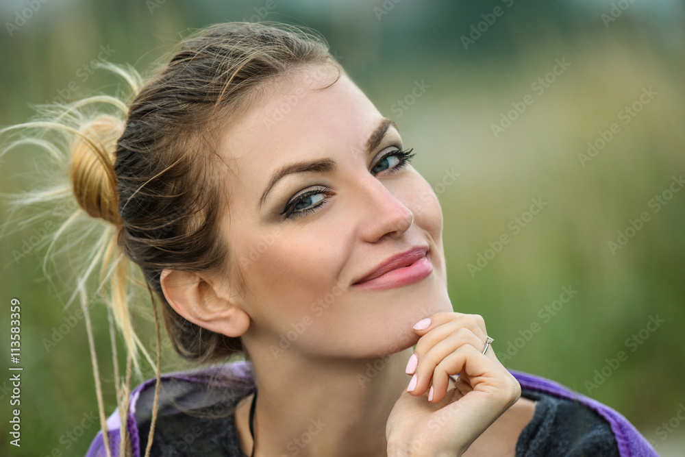 Outdoor portrait of beautiful smiling woman with bright professional make-up. Outdoor portrait of beautiful smiling woman with bright professional make-up.