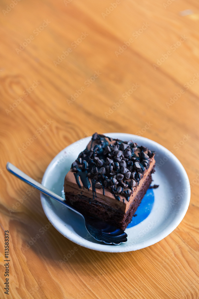 Dark chocolate cake on wood table
