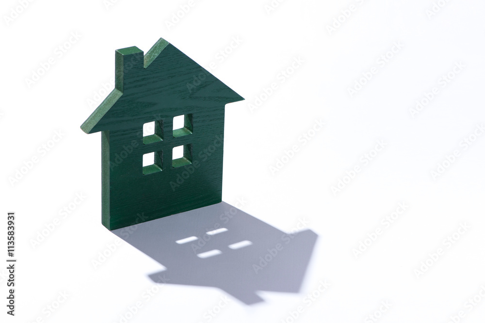 Wooden House Shaped. Model of the house on white background Wooden House Shaped. Model of the house on white background