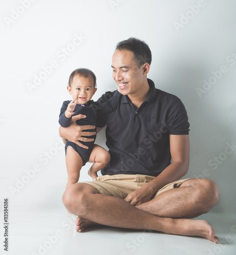 Young Asian father holding his adorable baby