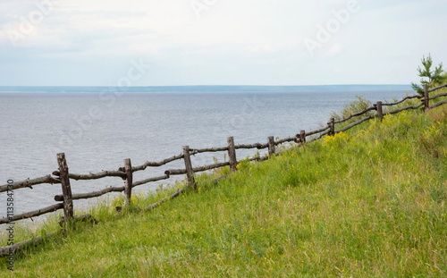 Wooden fence on the steep bank of the river