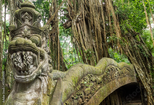 Dragon sculpture on the bridge in monkey forest, Ubud, Bali. © weltreisendertj