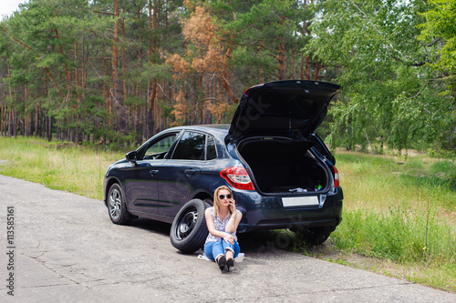 Young beautiful sexy woman at broken car with mobile phone, stan photo