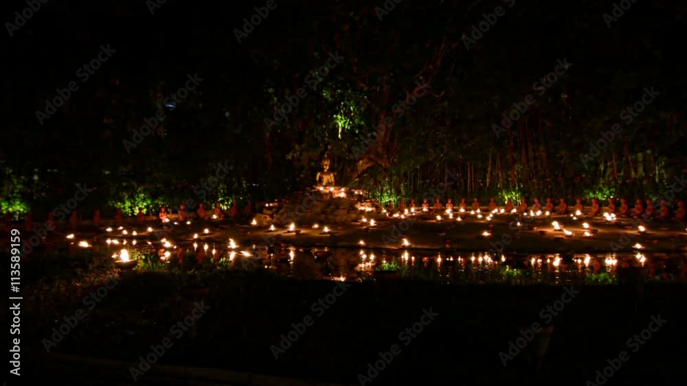 Magha puja day. Buddha surrounded by candles. Phan Tao Temple Magha puja day. Buddha surrounded by candles. Phan Tao Temple