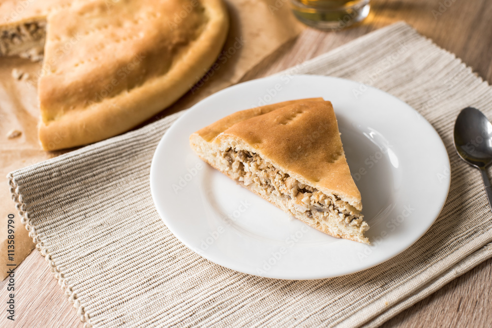 Pie with chicken, eggs and mushrooms on a white plate Pie with chicken, eggs and mushrooms on a white plate