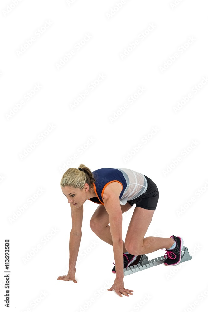 Female athlete in position ready to run