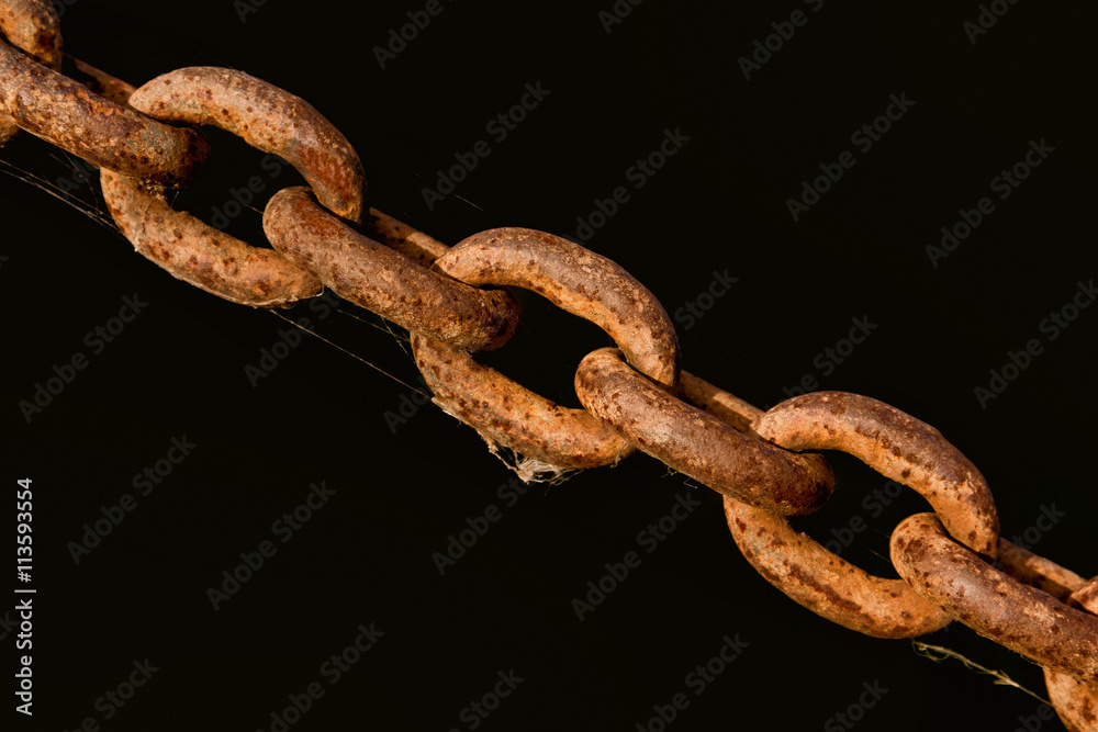 Fototapeta premium An old rusty chain on a black background