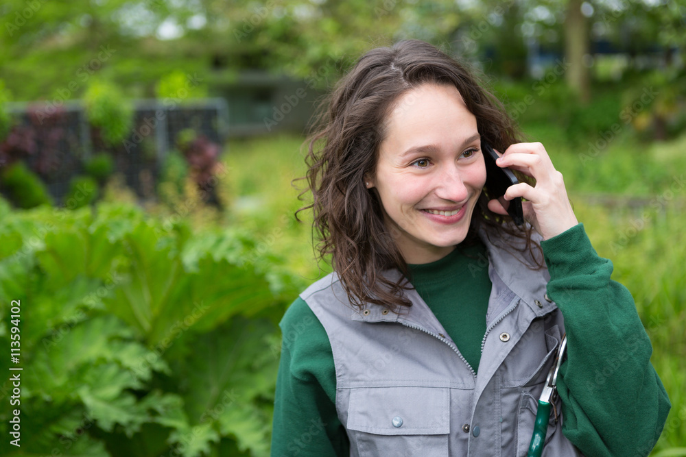 Young attractive woman working in a public garden using mobile Young attractive woman working in a public garden using mobile