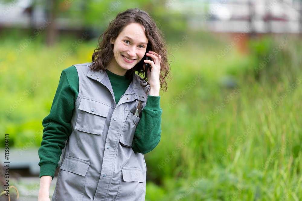 Young attractive woman working in a public garden using mobile Young attractive woman working in a public garden using mobile