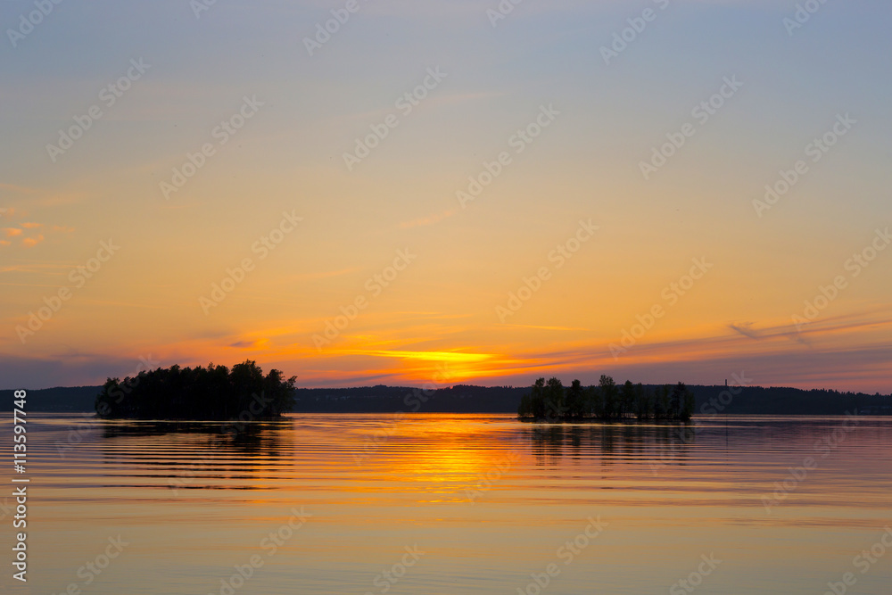 A beautiful scenery in the evening in Finland. A colorful sunset. Colorful sky with some clouds. 