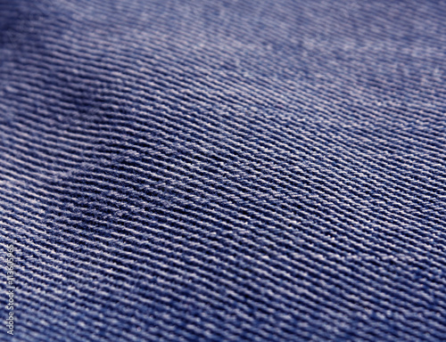 Color jeans textile texture close-up with blur effect.