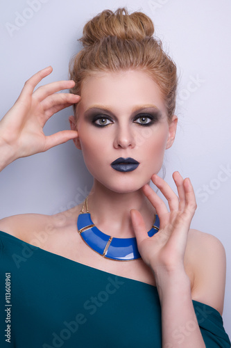 Beauty Fashion Model Woman face, perfect make-up. Sexy dark blue Lips. Beautiful Blond Woman with creative Makeup. Smokey eyes, brown eyes. Beauty Cosmetic Concept Girl Face dark Background
