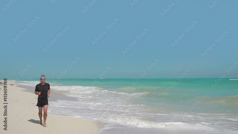 healthy male jogging on the beach tracking shot steadicam slow motion healthy male jogging on the beach tracking shot steadicam slow motion