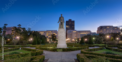 Statue and grave site of Huey Long on the grounds of the Louisiana State Capitol building at night in Baton Rouge, Louisiana photo