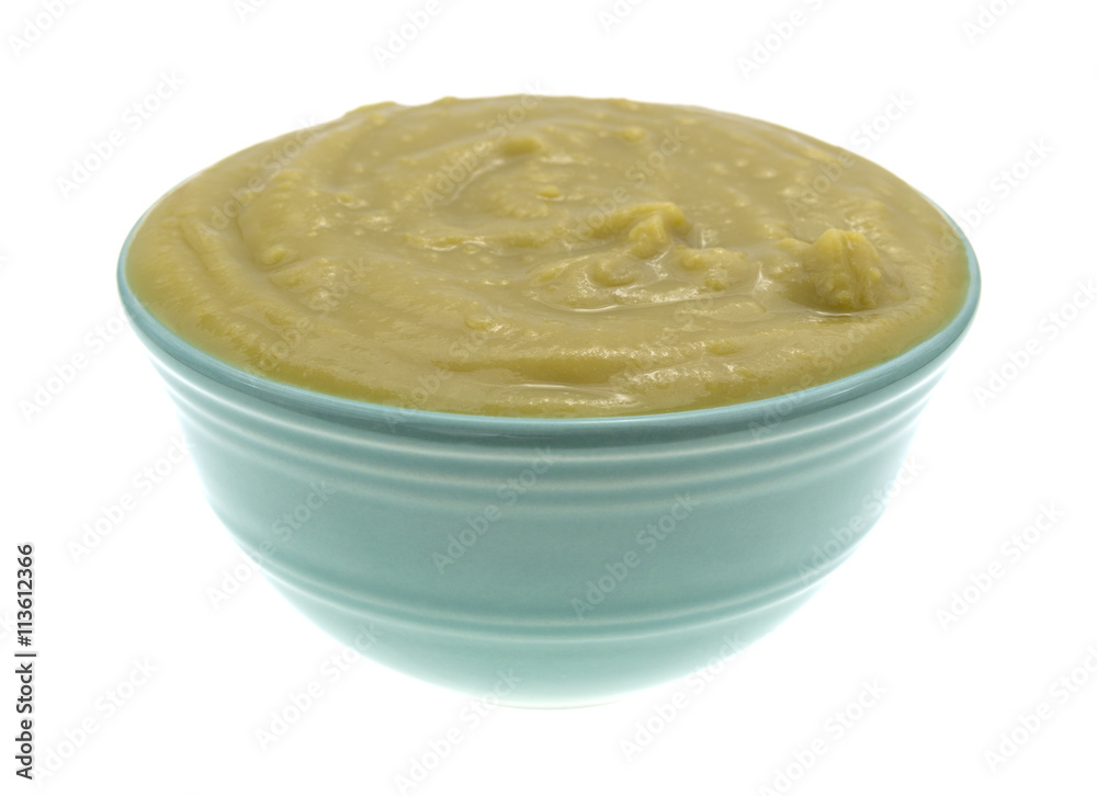 Bowl of green pea soup isolated on a white background side view. Bowl of green pea soup isolated on a white background side view.