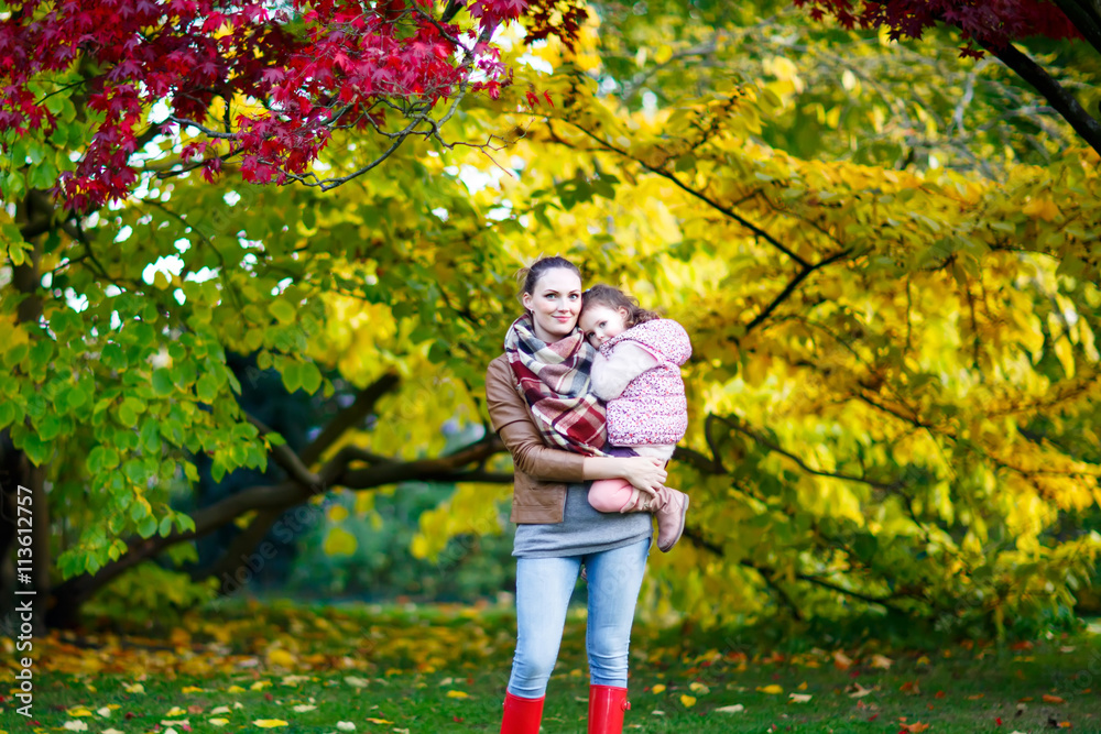 mother and her little daughter at beautiful autumn park mother and her little daughter at beautiful autumn park
