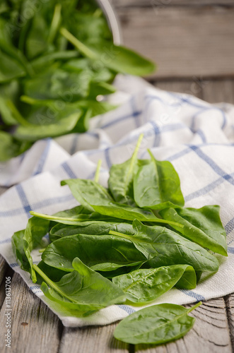 Fresh spinach leaves on rustic wooden background, selective focus, copy space photo