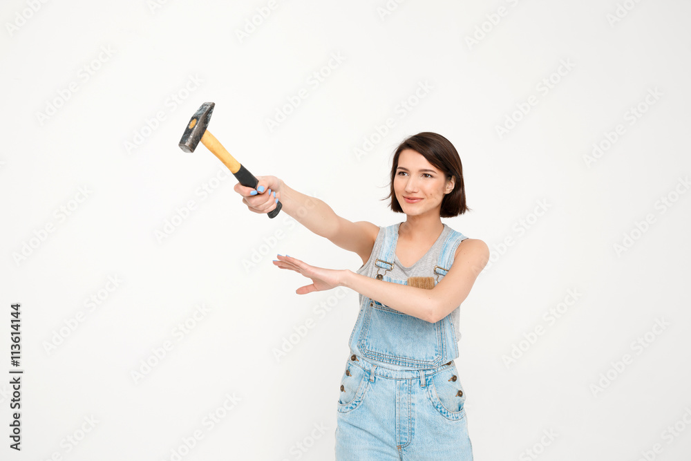 portrait of young beautiful girl, holding hammer portrait of young beautiful girl, holding hammer
