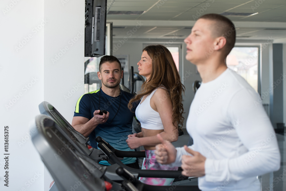Group Of People Running On Treadmills In Gym