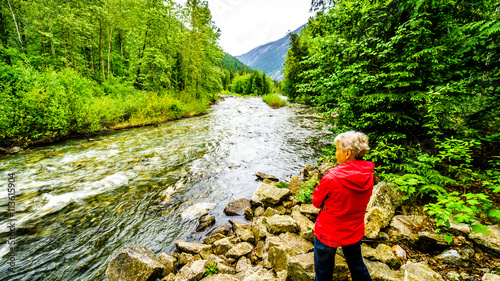 Senior Woman enjoying the View of Cayoosh Creek at the Cottonwood Campside along the Duffy Lake Road near Lillooet in British Columbia photo