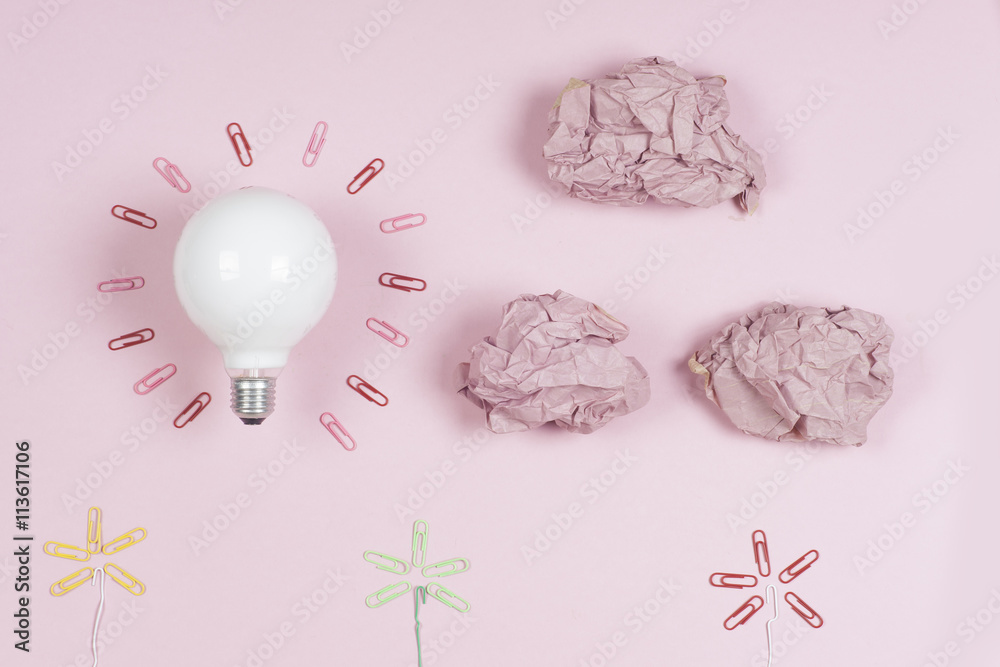 great idea concept with crumpled colorful paper and light bulb on light background. Creative brainstorm concept business idea. female hand holding light bulb. Copy space for text. great idea concept with crumpled colorful paper and light bulb on light background. Creative brainstorm concept business idea. female hand holding light bulb. Copy space for text.
